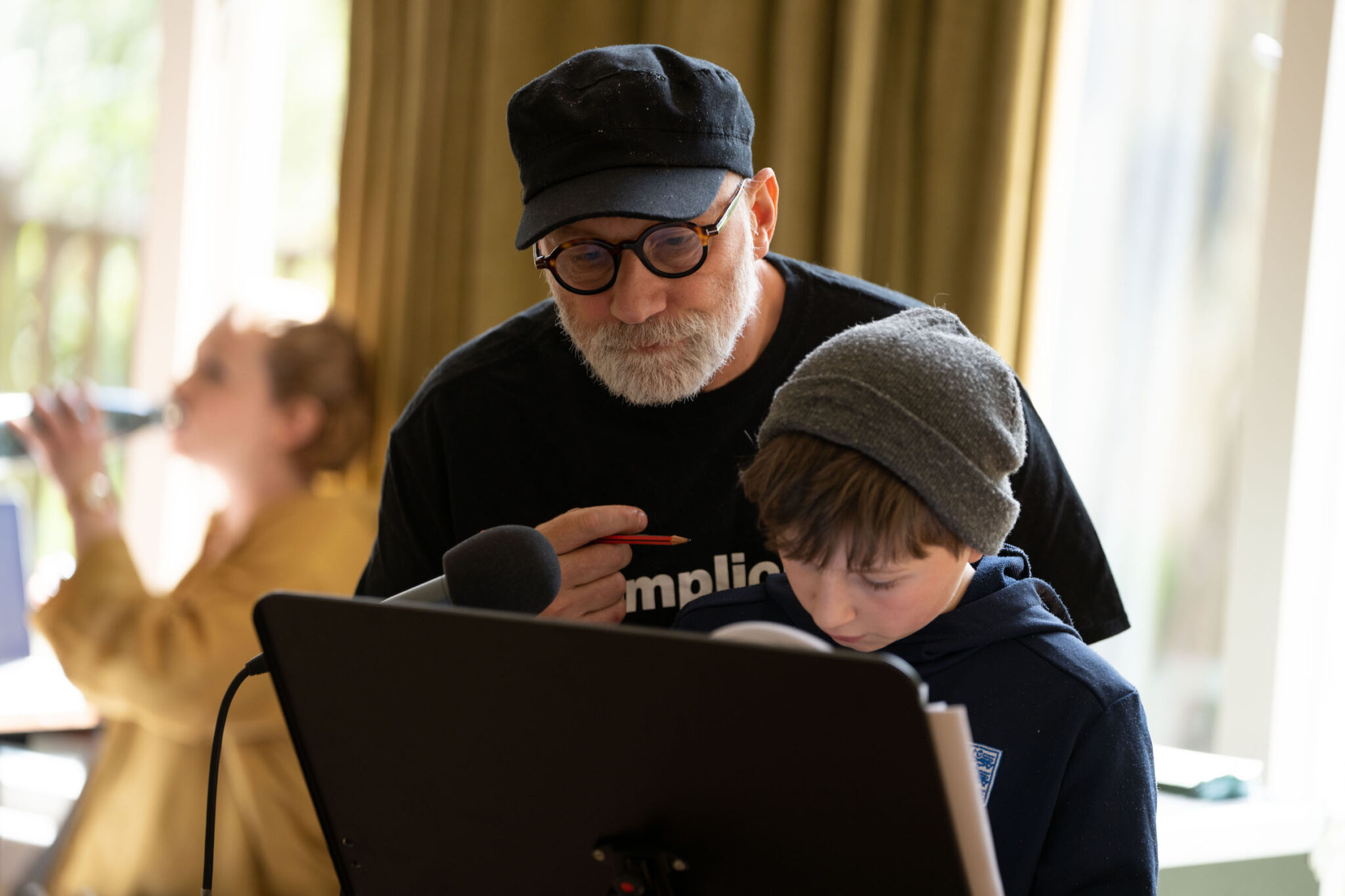 Simon McBurney and a child actor work on the script together at a music stand