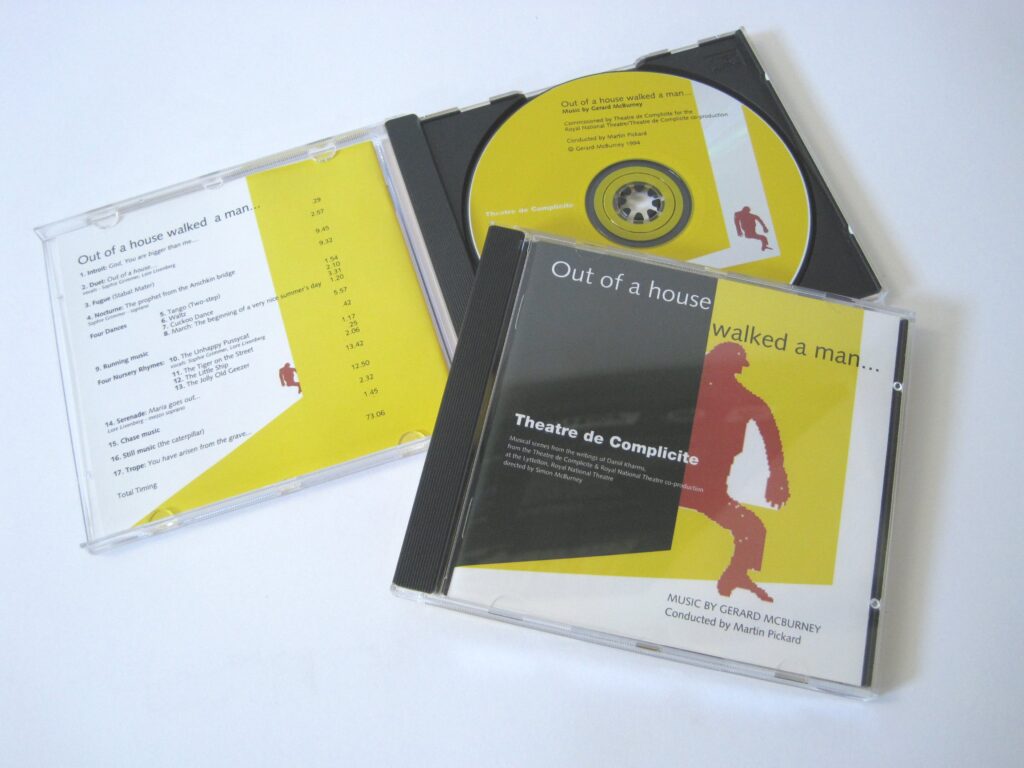 Two CDs of Out of a House Walked a Man, the CD on the bottom is open showing the yellow disc, while the CD on the top is closed, showing an orange figure stepping out of a black door into a yellow background.